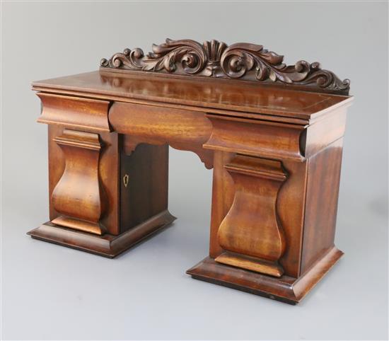 An early Victorian mahogany novelty tea caddy in the form of a twin pedestal sideboard, 15.75in. height 11in.